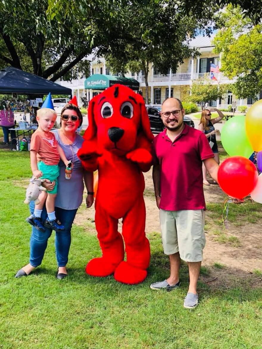 A family poses with Clifford the Big Red Dog at the Boerne Book and Arts Festival.