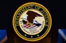 The U.S. Department of Justice logo is seen on a podium before a news conference, Monday, May 4, 2026, in Washington. (AP Photo/Julia Demaree Nikhinson)