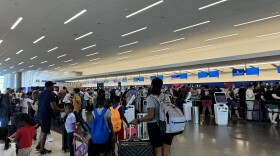 Travelers wait for help at the Salt Lake City International Airport Delta desk.