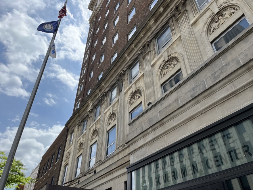  Exterior of the Lexington Fayette Government Center building at a low angle, the flagpole shown at full height to the left.