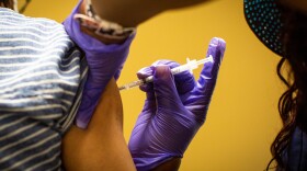 A COVID-19 vaccine is administered at a clinic hosted by the Central Texas Allied Health Institute in Austin on Saturday.