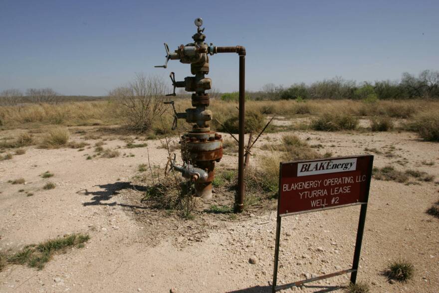 This is an image of an abandoned gas well located on a desert landscape in Texas. 