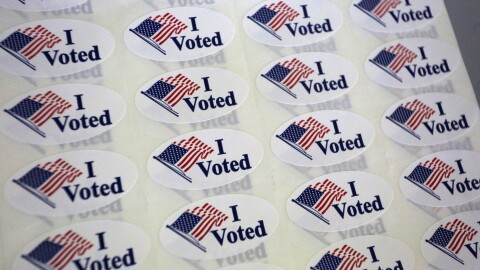 A close-up of sheets of I Voted stickers ready to be handed out to voters.