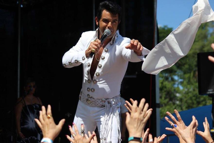 a white scarf being thrown into a crowd of Elvis fans at Elvisfest