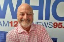 Larry Hansgen poses in front of WHIO sign.