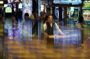In this June 24, 2021 photo, a dealer distributes cards to gamblers at Resorts World Las Vegas in Las Vegas.