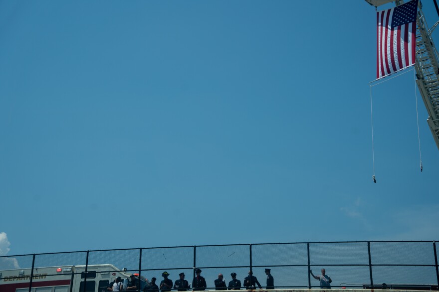 Bystanders watch the procession for fallen Lorain Police Officer Phillip Wagner on I-90 East.