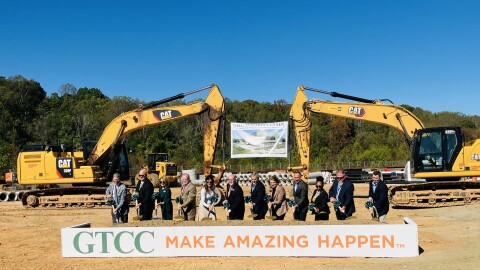 Guilford County and state officials shovel dirt at the groundbreaking site.