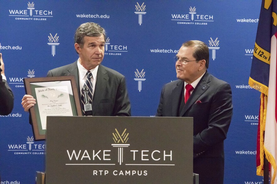 Wake Tech President Stephen Scott with Governor Roy Cooper as he received the Order of the Long Leaf Pine award, the highest honor for a private citizen in North Carolina.