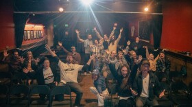 attendees at a film screening pose for a photo.