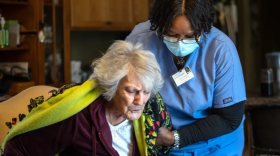 Direct care worker Sarah Sutherlin helping client, April 14, 2021