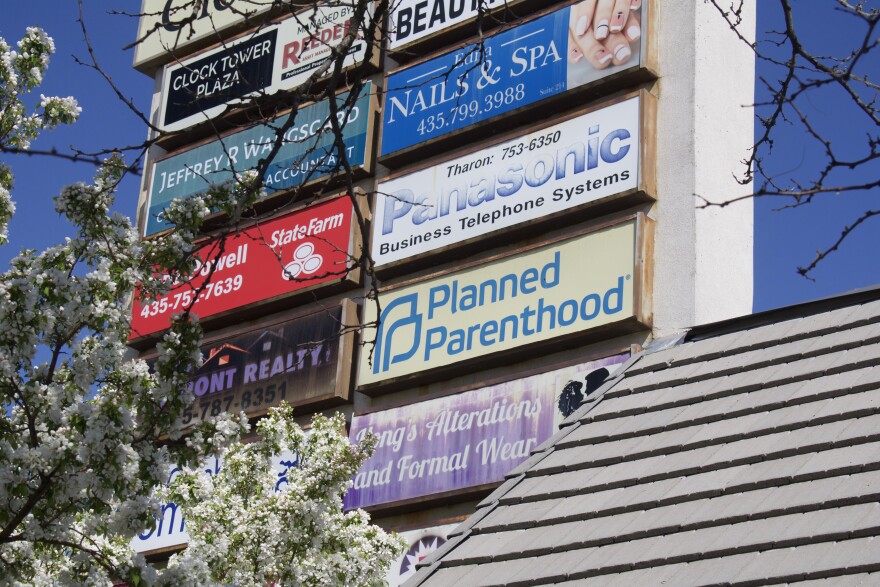 The Planned Parenthood sign is surrounded by signs from other businesses on the block. 