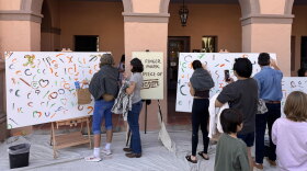 Local tucsonans paints on canvases during Tucson Meet Yourself at the historic Pima County Courthouse on Oct. 17, 2026.