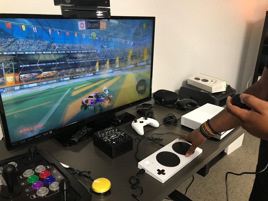 AbleGamers’ employee Greg Haynes uses an Xbox One adaptive controller to play a game called Rocket League.