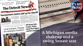 A Detroit newspaper next to a person filling in a ballot