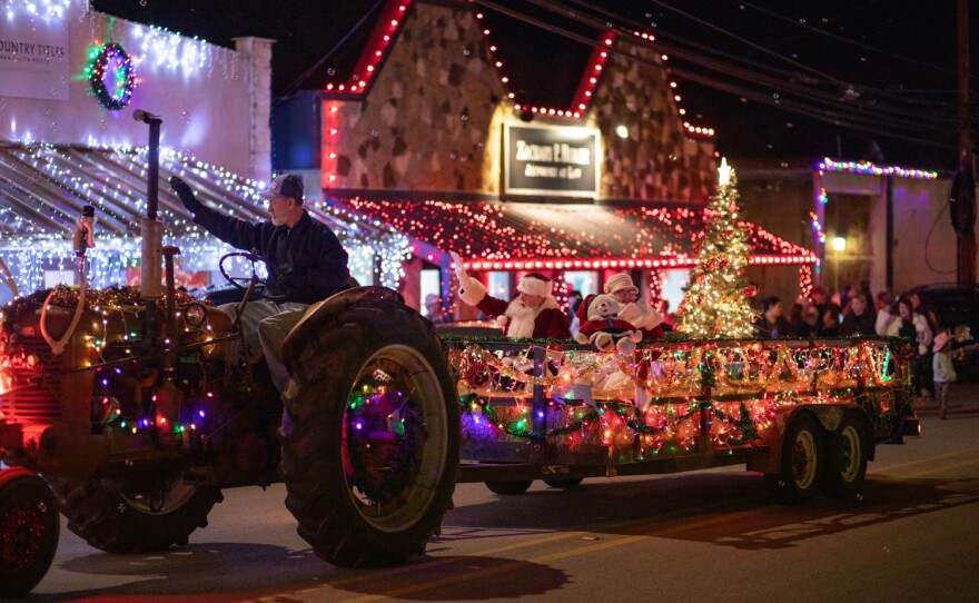 tractor pulls float in nighttime parade