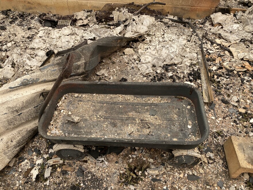 The remains of Holly's red wagon, a favorite toy. This was among the few visible possessions left behind at her parents' home following the Almeda Fire in Phoenix, Oregon.