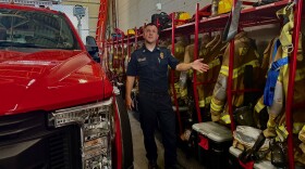 Assistant Fire Chief Travis Temarantz shows where firefighters keep their turnout gear so that it's separate from their civilian clothes.