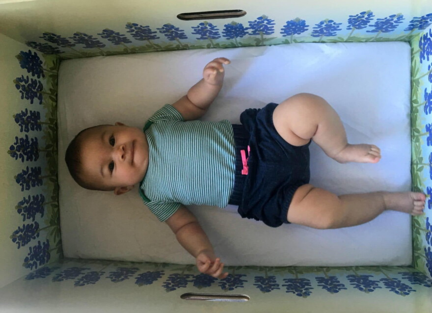 Penelope, 4 months old, in a "baby box." (Lauren Silverman/KERA)
