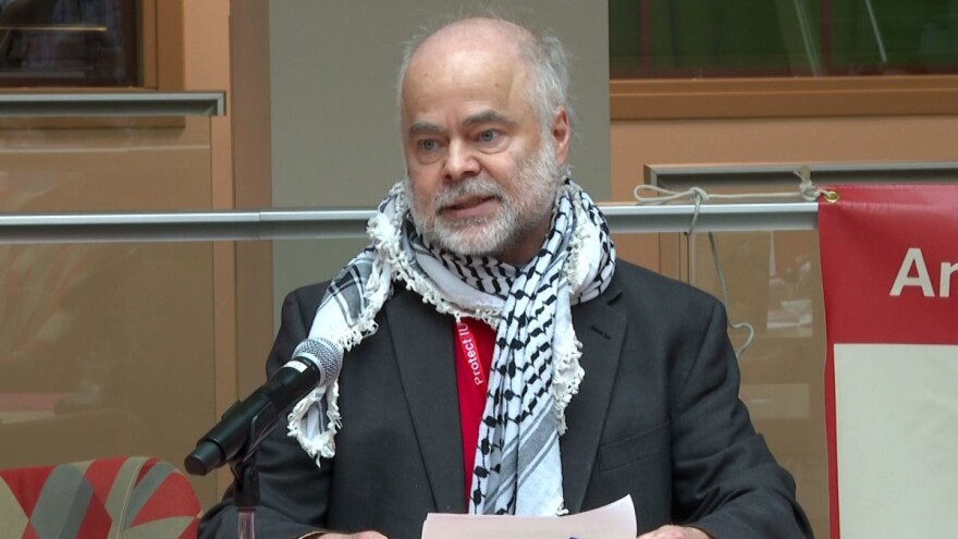 Indiana University professor Ben Robinson talks at during a "Day of Action" press conference on April 17.
