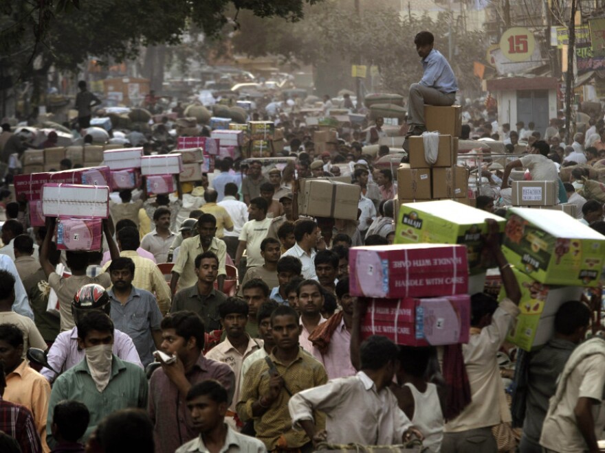 <p>Crowds pack a wholesale market in New Delhi. Already the second most populous country with 1.2 billion people, India is expected to overtake China around 2030.</p>