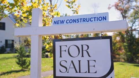 A sign is posted for a new home for sale