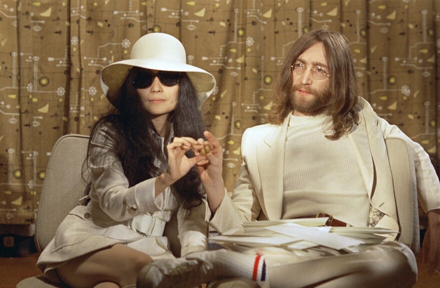 This 1969 photo shows musician John Lennon, right, and his wife Yoko Ono during a press conference. An album, "Gimme Some Truth" by John Lennon, will be released Friday, on what would have been his 80th birthday. (AP Photo, File)