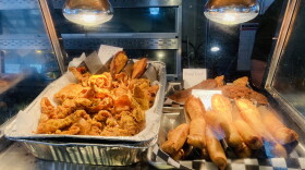 A photo inside a food-warmer shows egg rolls and empanadas.