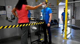 Employees at Kem Krest in Elkhart get temperature screenings upon entering the facility.