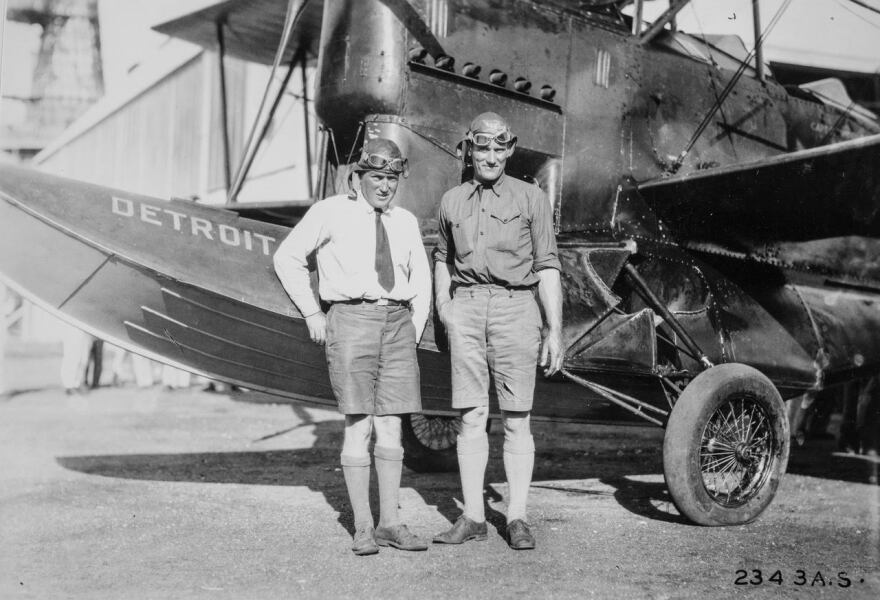 Pilots of the plane, Detroit, standing in front of the plane. 