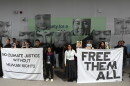 FILE - Demonstrators hold signs with images of environmental defenders during the COP29 U.N. Climate Summit, Nov. 20, 2024, in Baku, Azerbaijan.