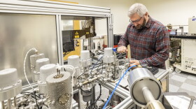 UAF geochronologist Florian Hoffman works on the program’s argon mass spectrometer. 