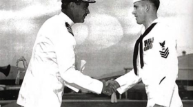 Petty Officer First Class Bill Curtis shakes Captain Ryan’s hand during a ceremonial event on September 8, 1961, at NAS North Island in San Diego, California.