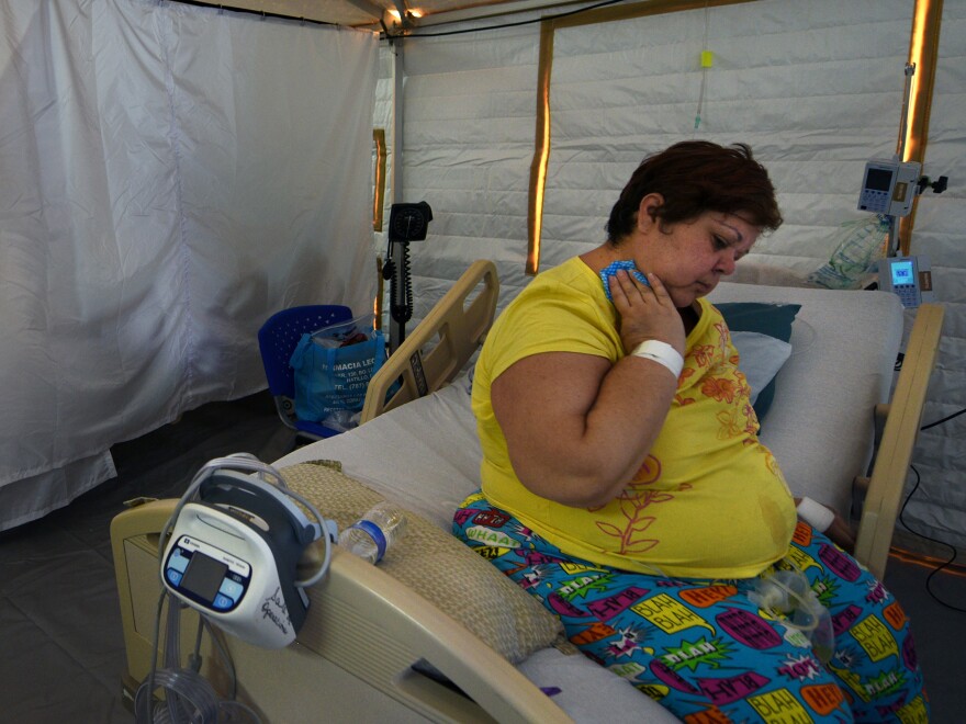 U.S. Disaster Medical Assistance Teams erected two cooled emergency rooms for critically ill patients at the hospital in Arecibo, Puerto Rico, where temperatures on the 6th floor soared to 112 degrees one day. Sarilin Lopez, grateful to be in the field hospital, says, "It was so hot I could hardly breathe."