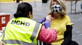 Woman receiving COVID-19 vaccine