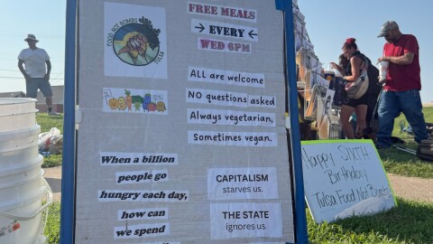 Signs displayed by Tulsa Food Not Bombs volunteers during one of their weekly "sharings."