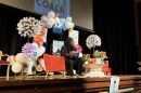 Writer on a stage expressively reads to an auditorium.