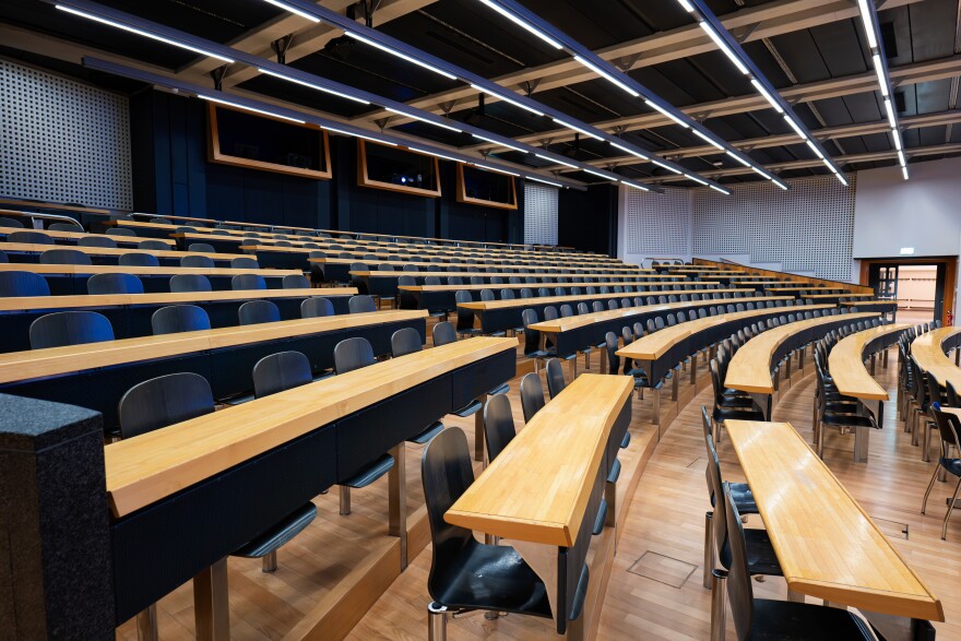 rows of seats and desks in a lecture hall