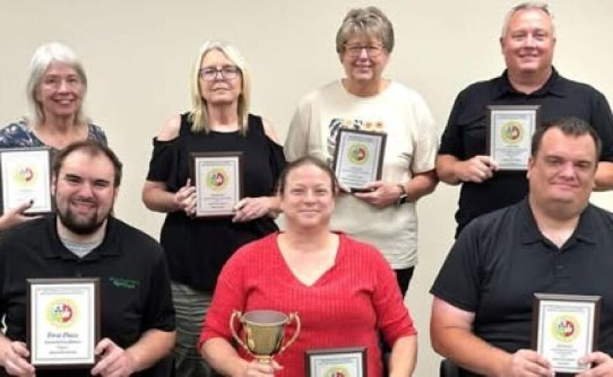 Maryville Forum employees holding 2026 Missouri Press Association awards (back row L-R) reporter Kathryn Rice, advertising manager Rita Piveral, advertising representative Twyla Martin and owner/publisher Phil Cobb and (front row L-R) news editor Geoffrey Woehlk, former managing editor Skye Pournazari and current managing editor Jon Dykstra.
