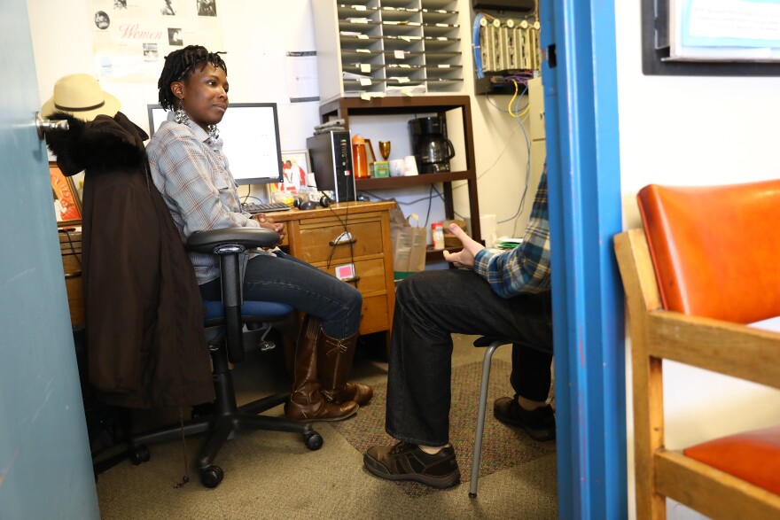 Shenise Morgan talks to a client in her office at the Tenant Resource Center in Madison, Wis. The center accepts walk-in appointments for anyone in Wisconsin needing advice on landlord, tenant or housing issues.