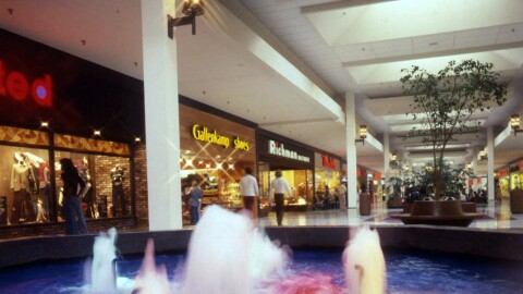 Shoppers walk in the Northland mall. Water fountain in the foreground.
