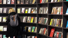 A visitor looks at books displayed. (Daniel Roland/AFP via Getty Images)