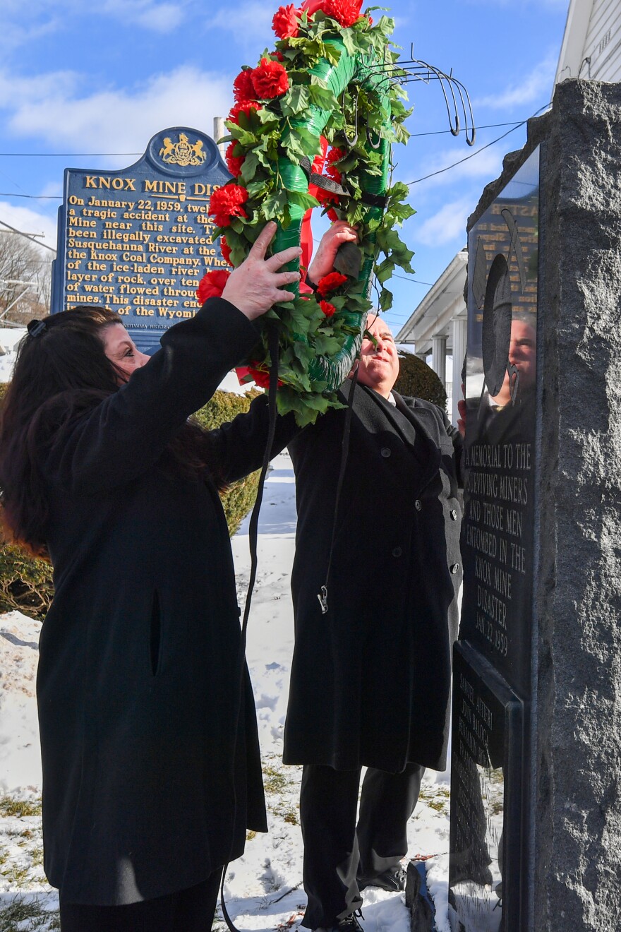 The Baloga family places a wreath on the monument to the 12 miners that died in the Knox Mine disaster of 1959, including their grandfather.