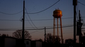 Crows fly past the Murphysboro, Illinois water tower during sunrise on Tuesday, March 19, 2024.