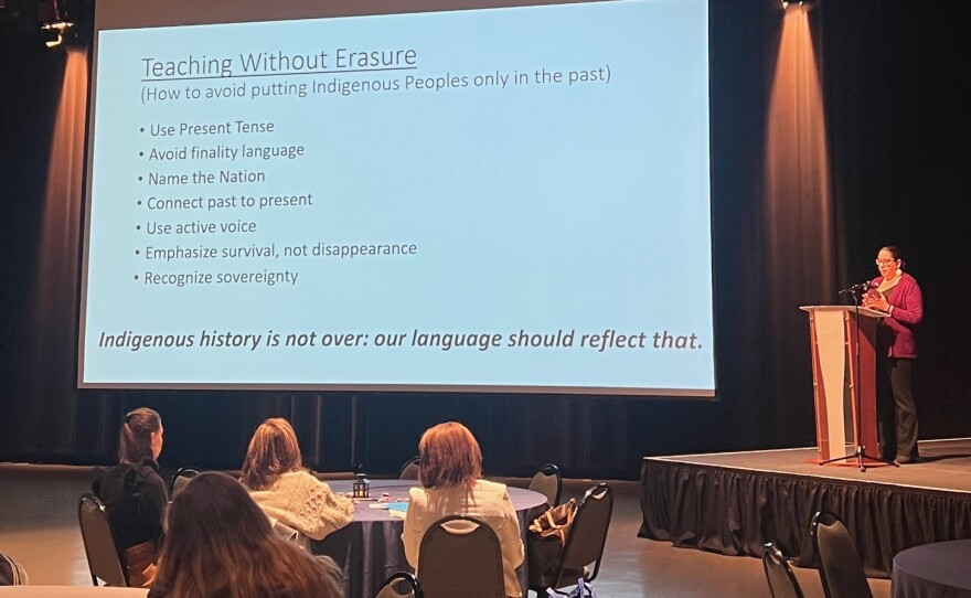 Melissa speaking to the audience from a podium