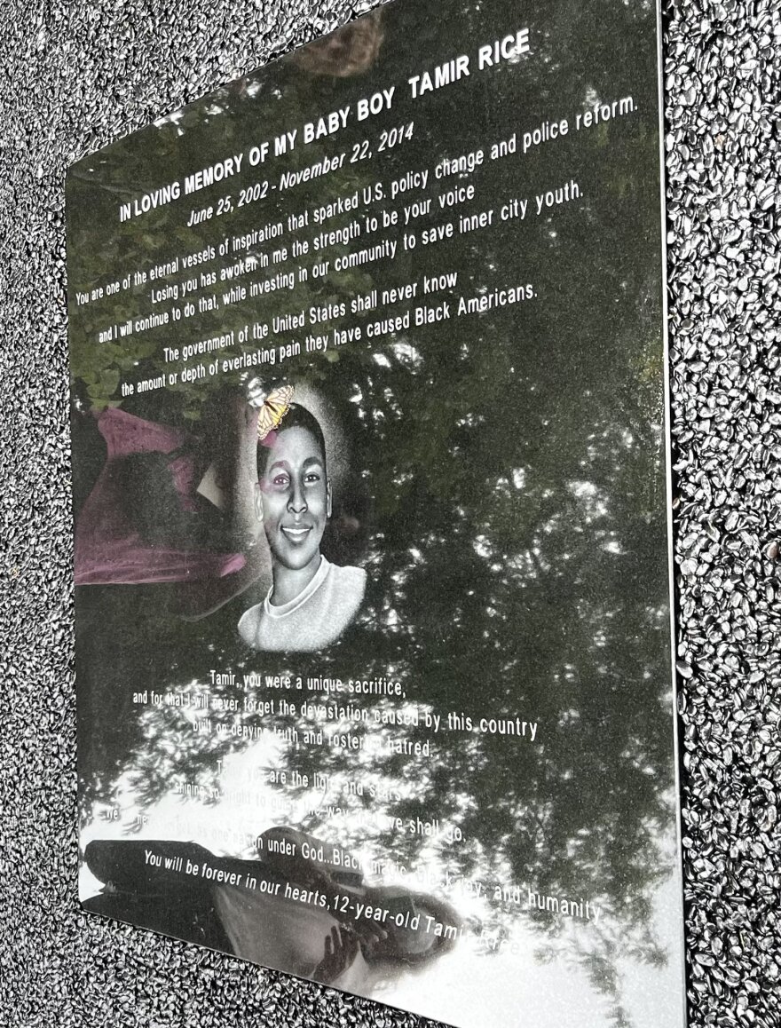 A butterfly lands on the Tamir Rice plaque in his memorial garden.