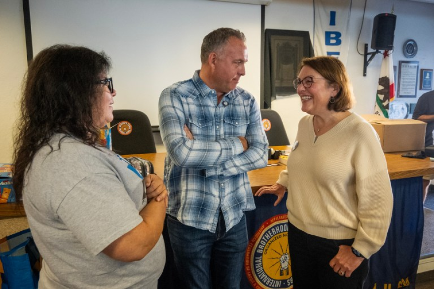 At center, U.S. Rep Adam Gray meets with Congresswoman Suzan DelBene, right, and Lisa Mantarro-Moore, left, following a meeting with supporters at IBEW Local 684 in Modesto before canvassing a neighborhood on Oct. 10, 2026.
