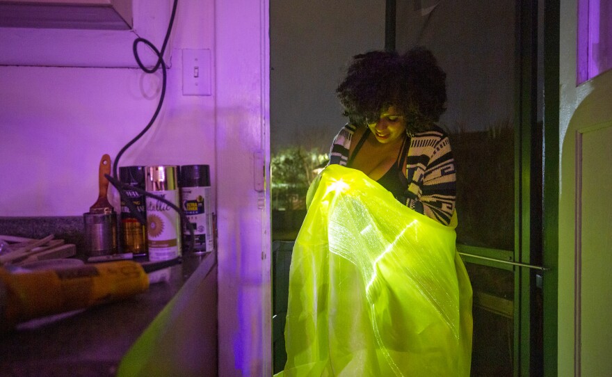 Women of Wakanda member Sonita Singh works with her fiber optic embedded cloth that she will attach to her costume.