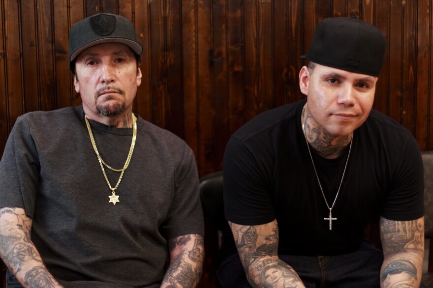 Freddy Negrete (left) at the Shamrock Social Club where he tattoos alongside his son, Isaiah.