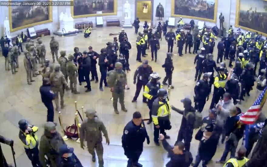 In this image from U.S. Capitol Police security video, police and rioters are seen in the Rotunda of the Capitol on Jan. 6, 2021, in Washington, D.C. (U.S. Capitol Police via AP)